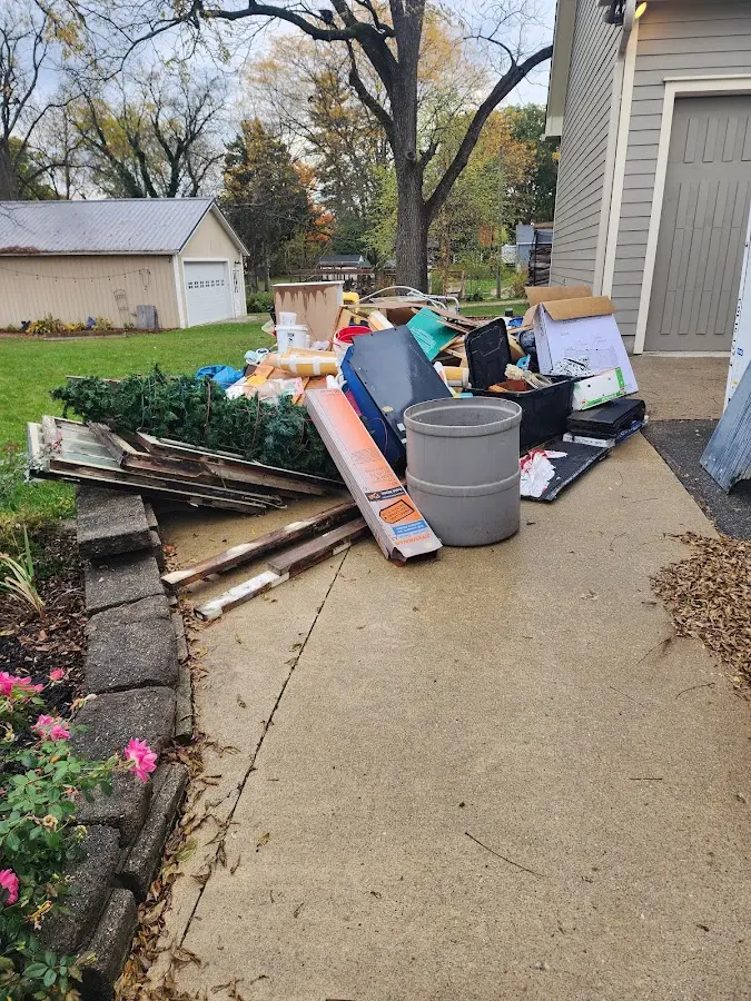 Dumpster being loaded with debris for Estate Cleanout Dumpster Rental in Martinez